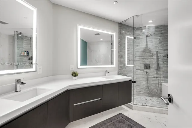 a bathroom with a bathtub shower sink mirror and toilet
