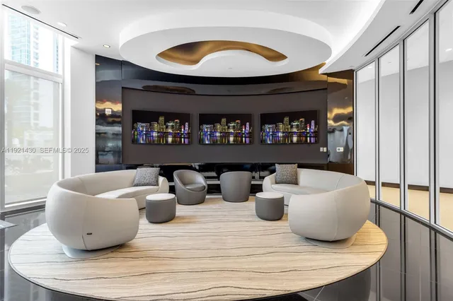 a lobby with furniture and floor to ceiling window