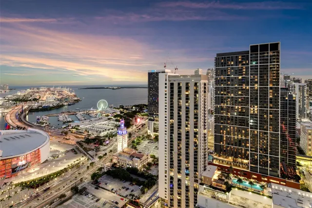 a dining room with wooden floor and large window