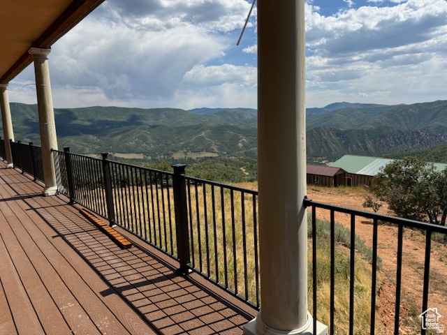 6909 East Spring Drive, Unit 19 Springville, UT 84663 - Photo 68 of 118 Expansive outdoor deck featuring wood-finish flooring, classic white columns, and black metal railings