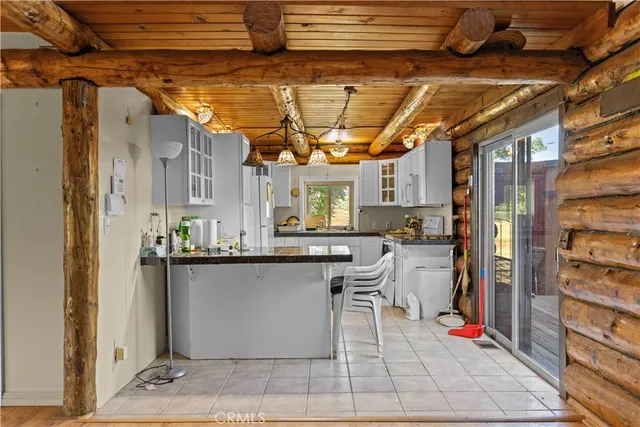 a kitchen with stainless steel appliances granite countertop a sink and a refrigerator