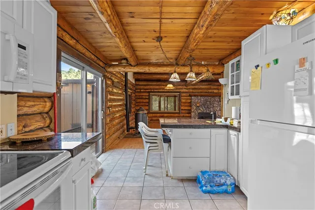 a kitchen with a sink a refrigerator and cabinets