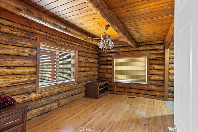 a view of a room with wooden floor and windows
