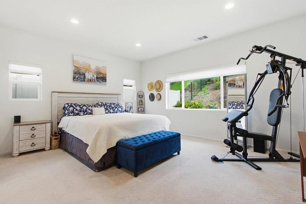 35647 Garrano Lane Fallbrook, CA 92028 - Photo 19 of 67 a spacious bedroom with a bed a couch and a window