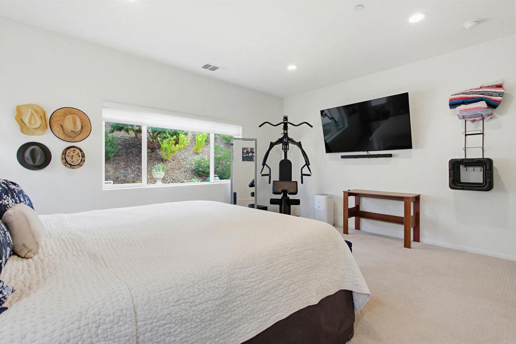 35647 Garrano Lane Fallbrook, CA 92028 - Photo 20 of 67 a bedroom with a bed a flat screen tv and a window