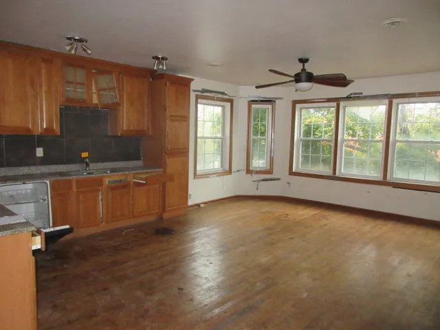 a view of a kitchen with a sink and cabinets