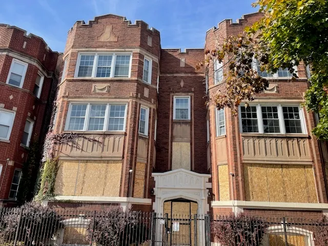 a front view of a residential apartment building with a yard