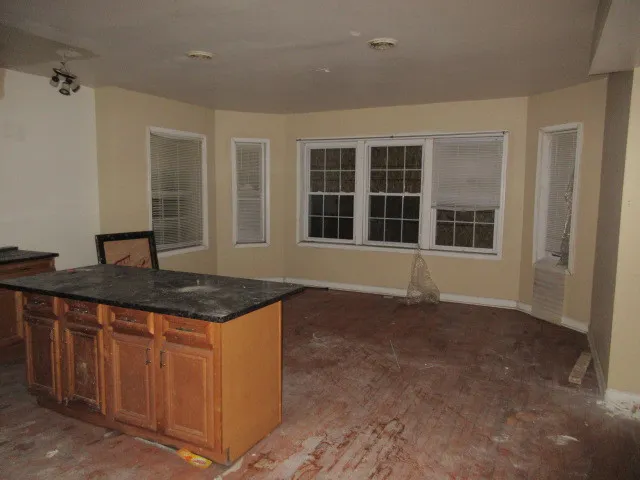 a kitchen with granite countertop a sink and a stove