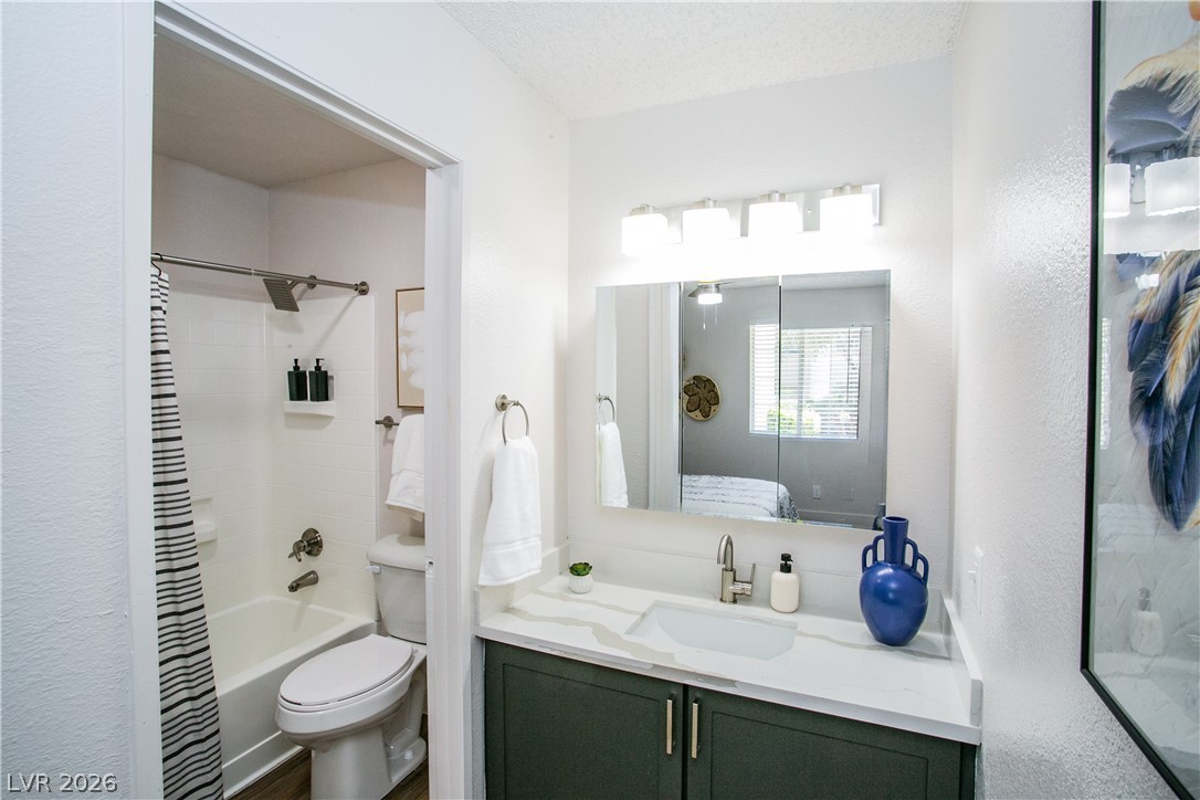 6750 Del Rey Avenue, Unit 108 Las Vegas, NV 89146 - Photo 6 of 11 This bathroom features a sleek vanity, a combination shower and tub, and ample lighting.