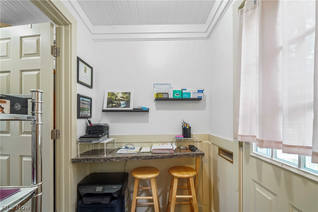 629 Clinton Street Niles, OH 44446 - Photo 21 of 50 Built-in desk featuring a stone-finish countertop, beadboard ceiling, white paneled door, and floating wall shelves