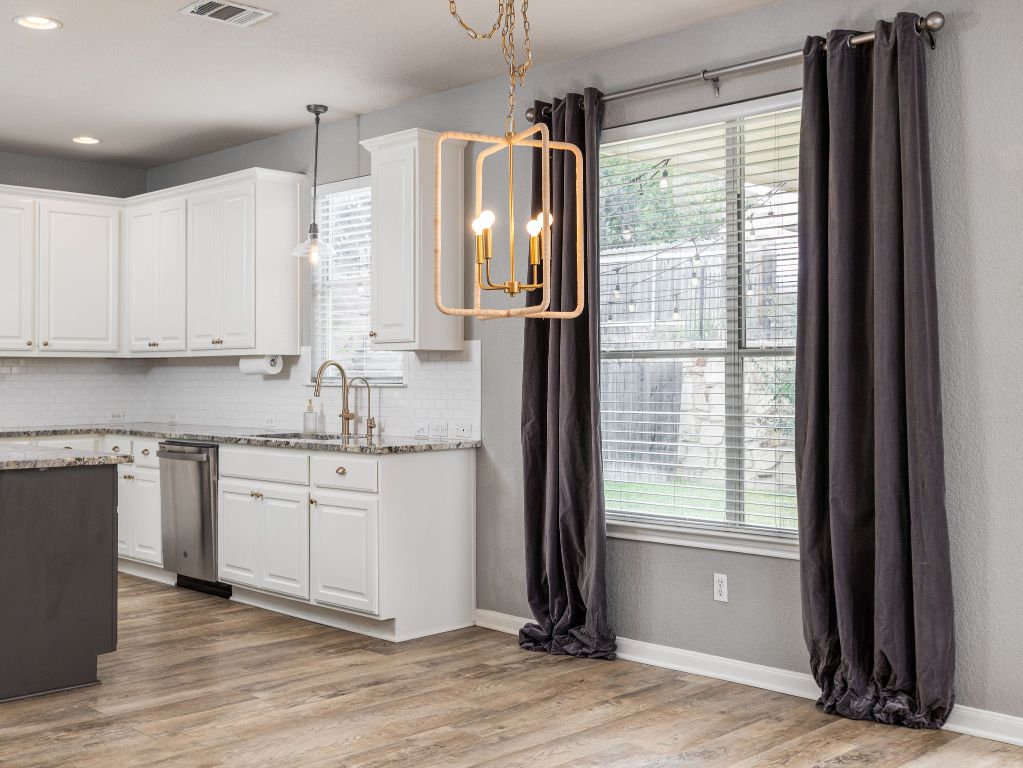 2349 Caprock Place Georgetown, TX 78626 - Photo 11 of 38 a kitchen with stainless steel appliances granite countertop a refrigerator and a sink