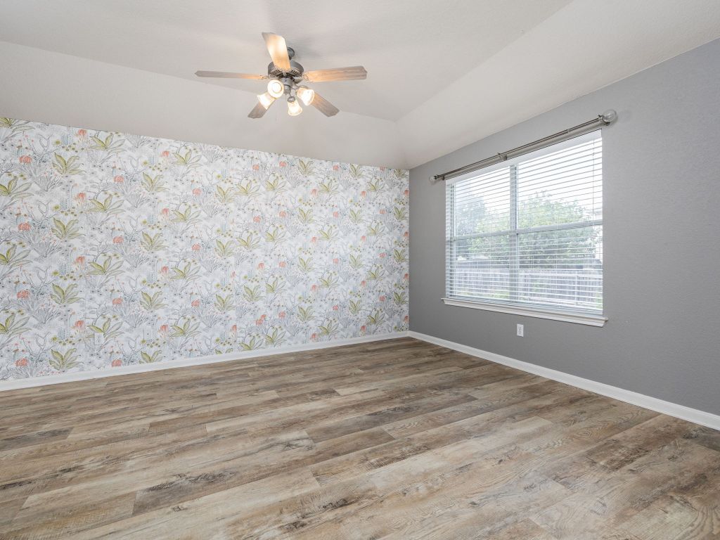 2349 Caprock Place Georgetown, TX 78626 - Photo 19 of 38 a view of a big room with wooden floor and a chandelier fan