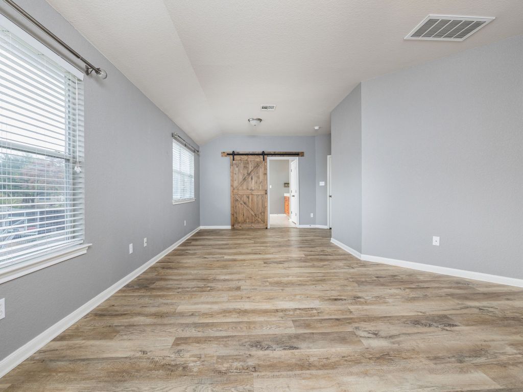 2349 Caprock Place Georgetown, TX 78626 - Photo 20 of 38 a view of an empty room with wooden floor and a window