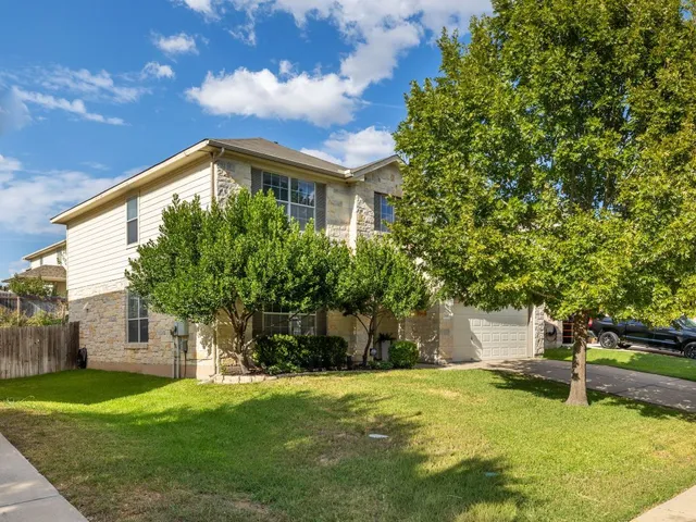 a front view of house with a garden