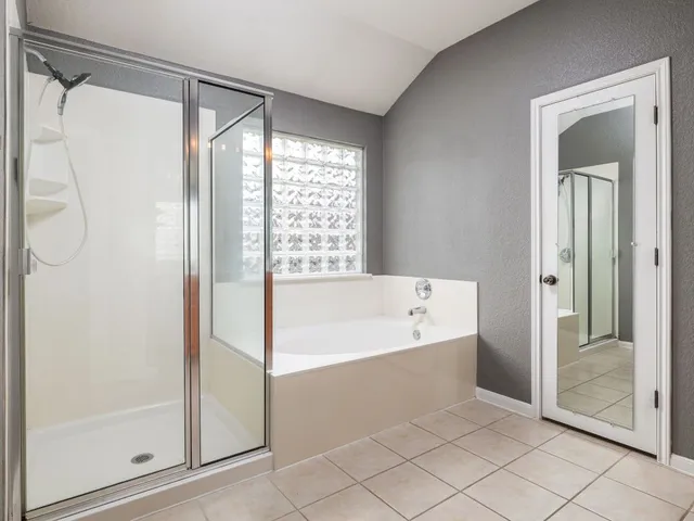 a bathroom with a bathtub and a shower
