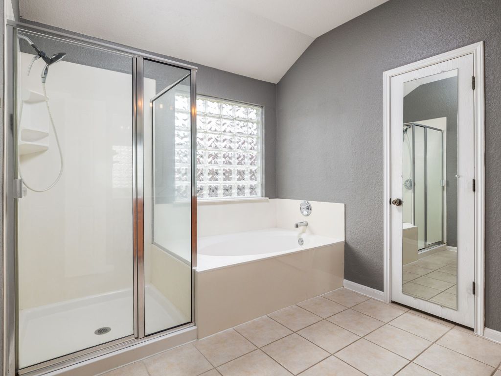 2349 Caprock Place Georgetown, TX 78626 - Photo 21 of 38 a bathroom with a bathtub and a shower