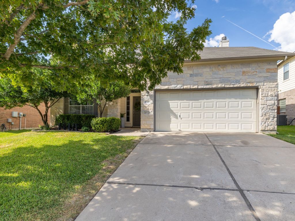 2349 Caprock Place Georgetown, TX 78626 - Photo 3 of 38 a front view of a house with a yard and a garage