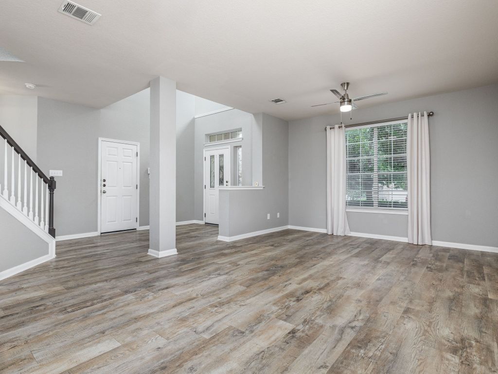 2349 Caprock Place Georgetown, TX 78626 - Photo 6 of 38 a view of an empty room with wooden floor and a window