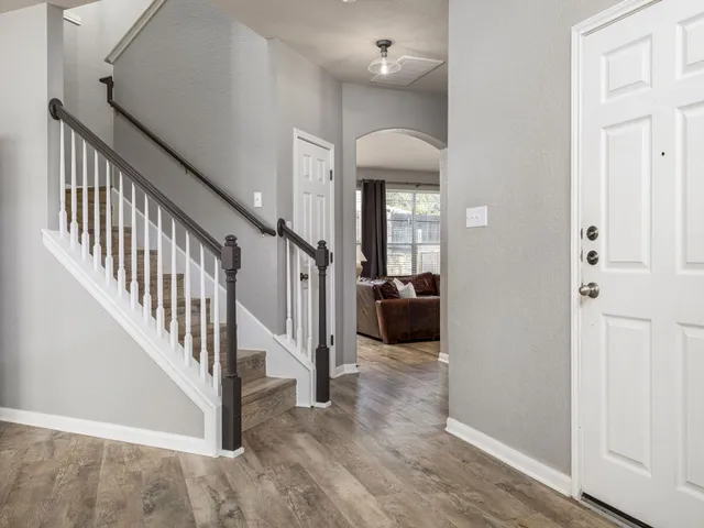 a view of a livingroom with a dinning area hardwood floor and hallway