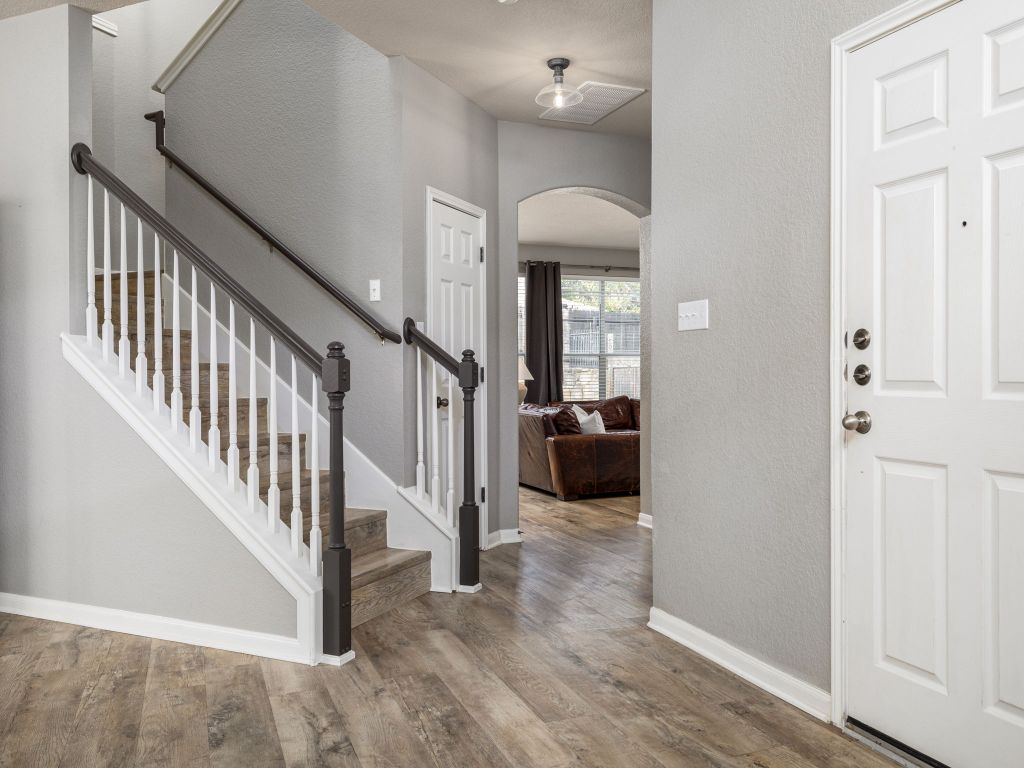 2349 Caprock Place Georgetown, TX 78626 - Photo 7 of 38 a view of a livingroom with a dinning area hardwood floor and hallway