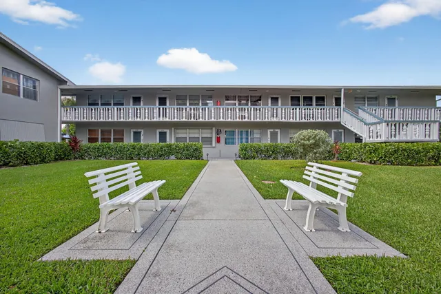 a view of a brick house with a yard