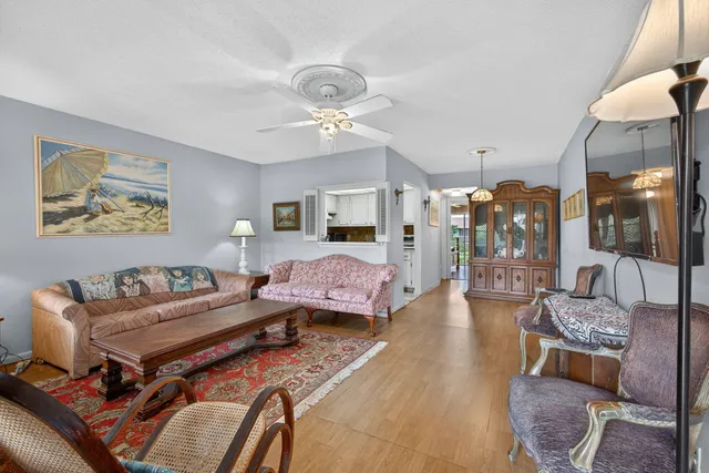 a living room with furniture fireplace and a chandelier