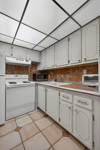 a kitchen with cabinets appliances and a sink