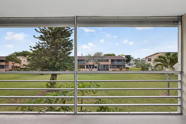 a view of a balcony with a green space