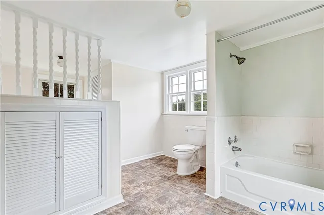 a bathroom with a toilet a sink and bathtub