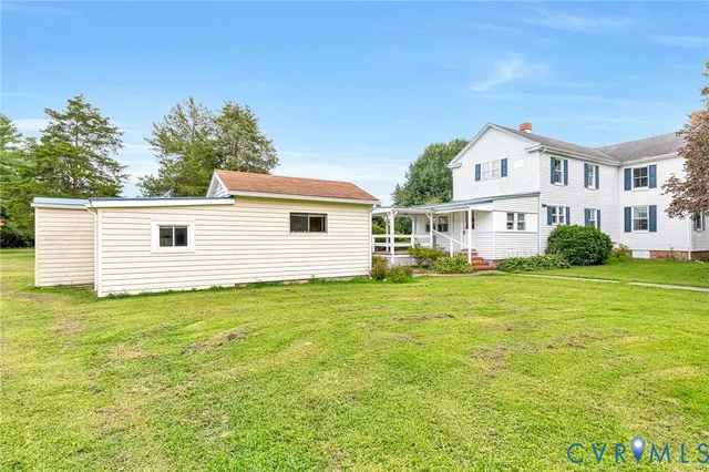a view of a white house with a yard