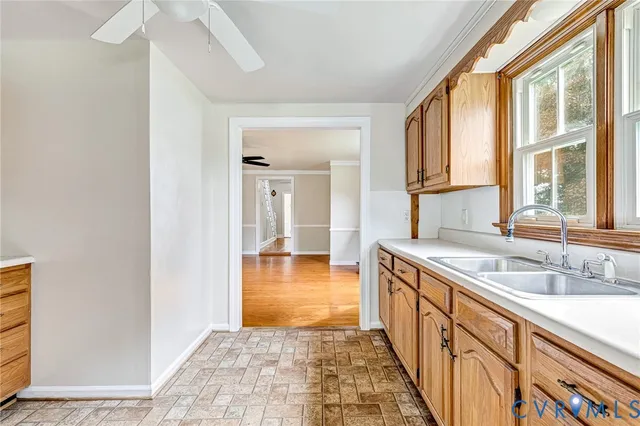a bathroom with a granite countertop sink and a window