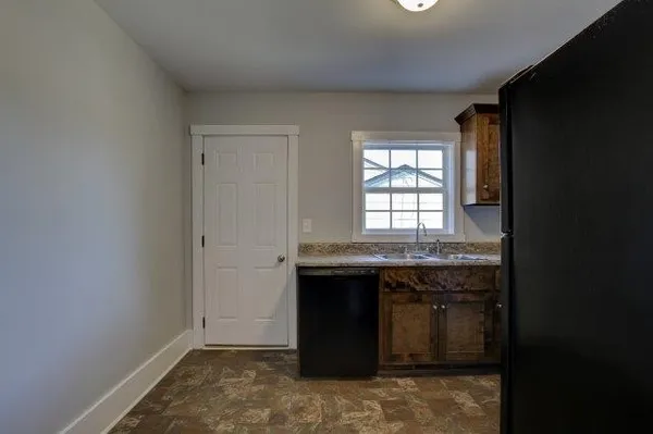 a kitchen with a sink stove and refrigerator