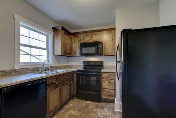 a kitchen with a refrigerator stove and sink