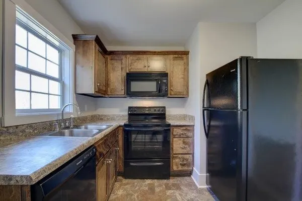 a stove top oven sitting inside of a kitchen