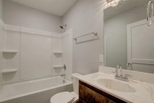 an empty room with window and ceiling fan