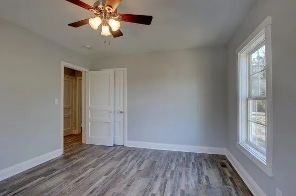 a view of a house with wooden deck and backyard