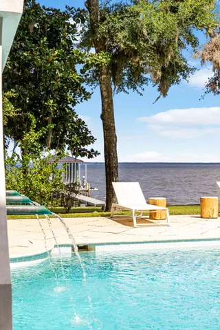 a view of a swimming pool with an outdoor space and seating area