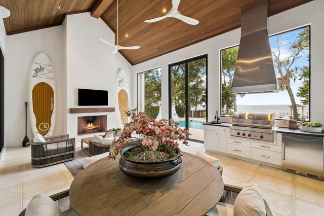 a living room with fireplace furniture and a large window