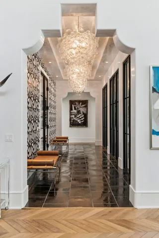 a living room with furniture and a chandelier