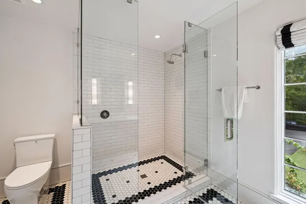 a bathroom with a toilet and shower