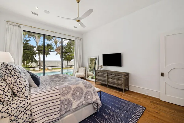 a bedroom with a bed and wooden floor