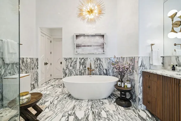 a spacious bathroom with a bathtub and shower