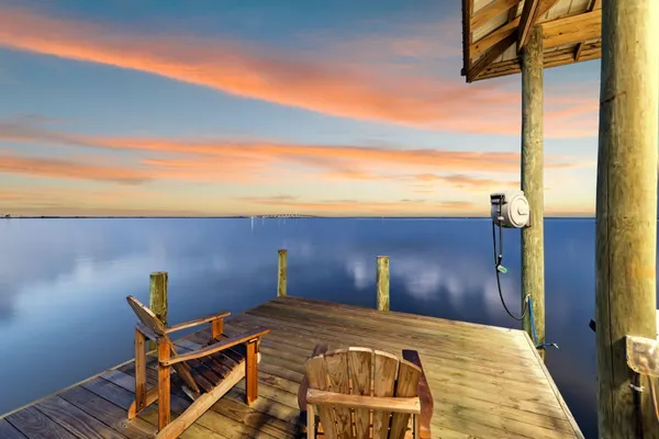 a bedroom with a bed and a view of balcony