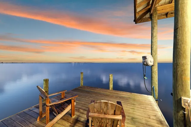 a bedroom with a bed and a view of balcony