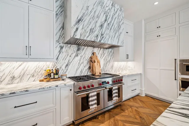 a kitchen with stainless steel appliances a stove and a refrigerator