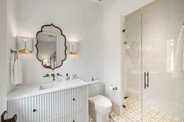 a bathroom with a sink toilet and a mirror