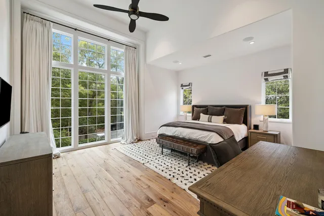 a bedroom with a large bed and a large window