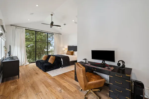 a view of a workspace with furniture and a window