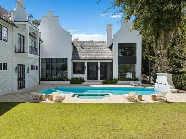a view of a house with swimming pool and a yard