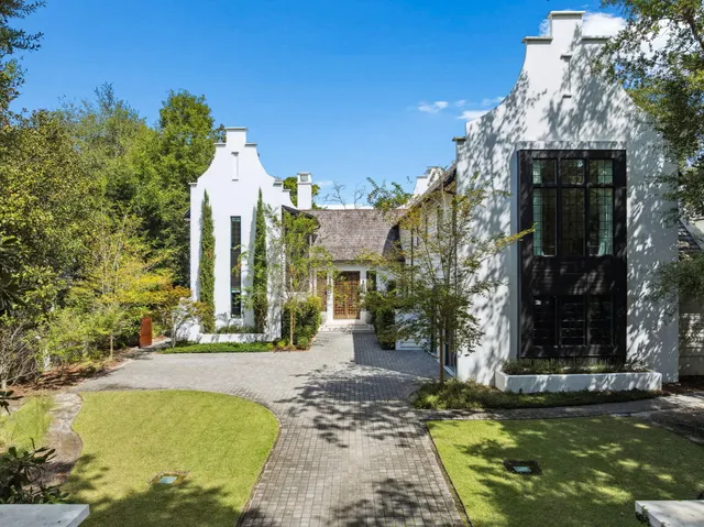 a view of a house with swimming pool and sitting area